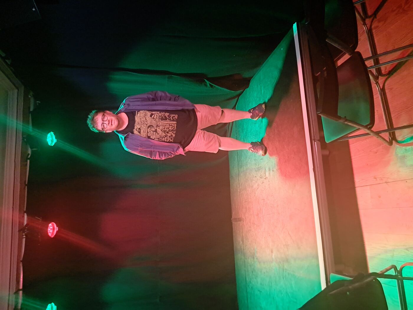 An empty theatre stage with Mark Stringer standing on it